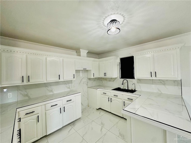 kitchen featuring white cabinetry and sink