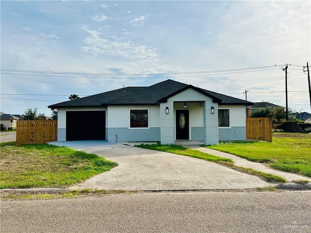 single story home featuring a garage and a front yard