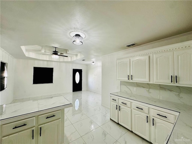 kitchen with a tray ceiling and ceiling fan