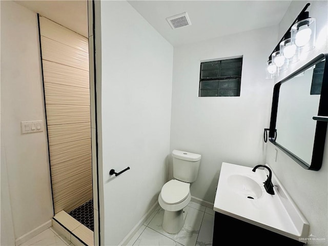 bathroom featuring vanity, toilet, and walk in shower