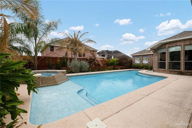 view of swimming pool with an in ground hot tub and a patio area