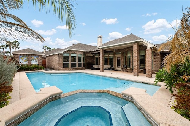 view of swimming pool featuring an outdoor hangout area, a patio, and an in ground hot tub