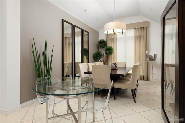 tiled dining space with vaulted ceiling