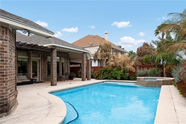 view of pool with a patio area and an in ground hot tub