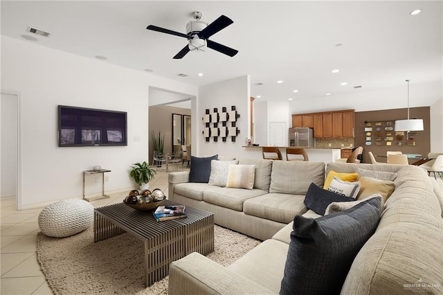 living room with light tile patterned floors and ceiling fan