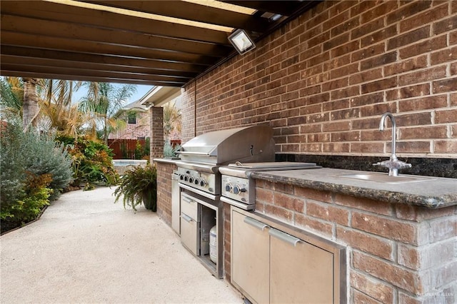 view of patio / terrace featuring area for grilling and sink