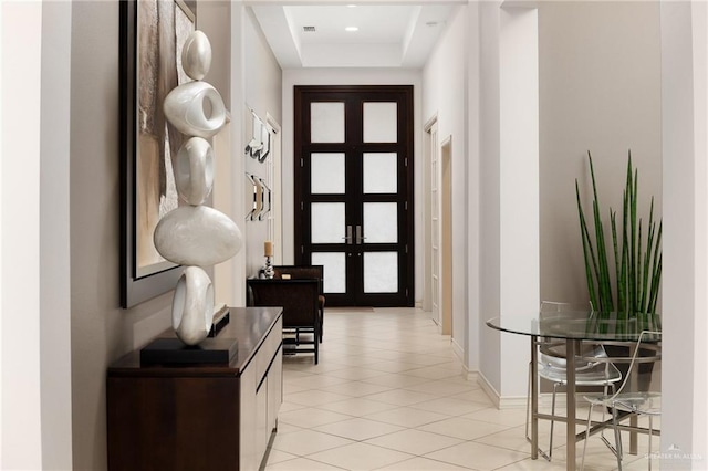 doorway with light tile patterned floors and french doors