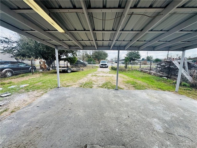 view of patio / terrace featuring a carport and fence