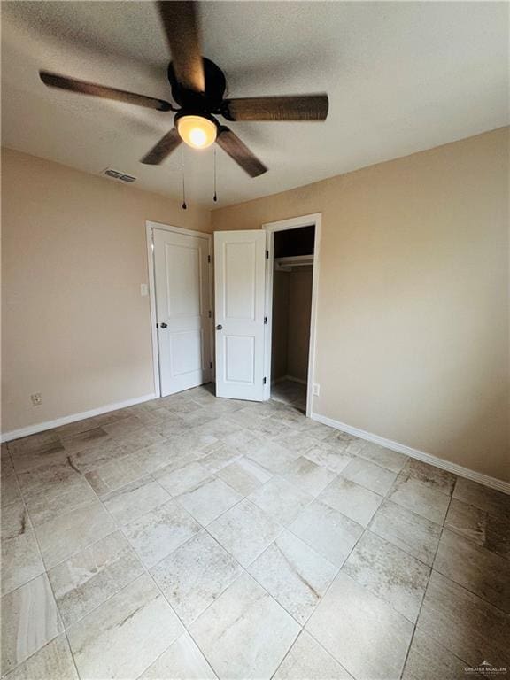 unfurnished bedroom featuring a ceiling fan, a closet, visible vents, and baseboards