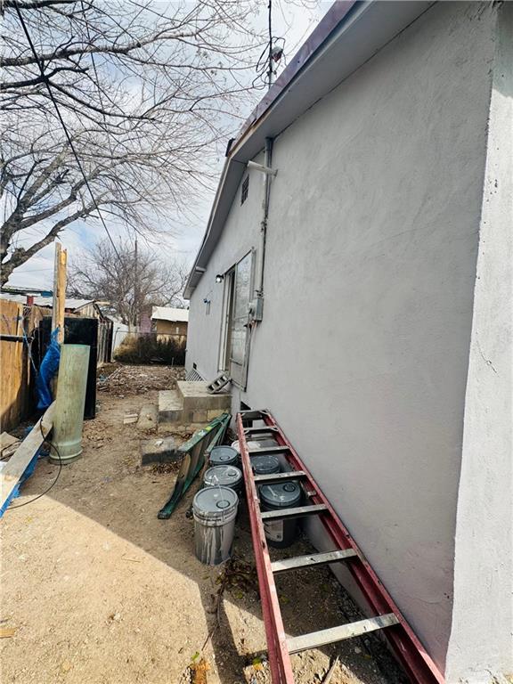 view of home's exterior with fence and stucco siding