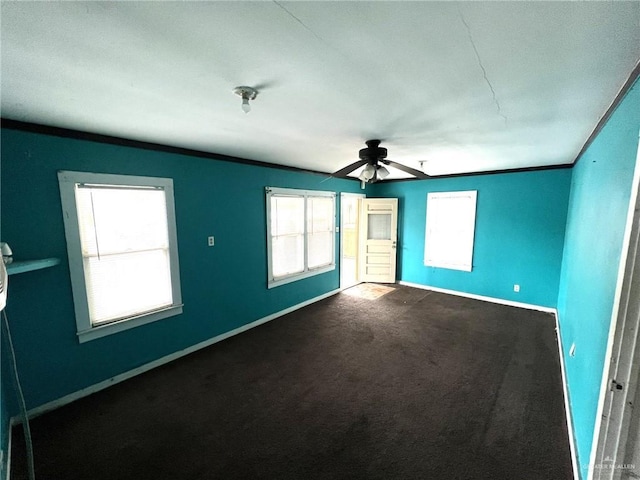 unfurnished room with a ceiling fan, baseboards, and carpet flooring