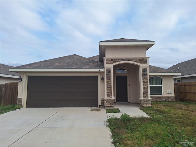 view of front of house with a garage and a front lawn