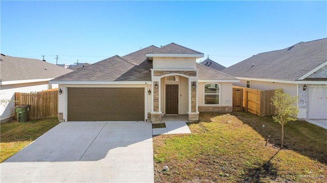 view of front facade featuring an attached garage, fence, concrete driveway, stone siding, and a front lawn