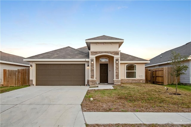 view of front facade featuring a garage, concrete driveway, fence, and stone siding