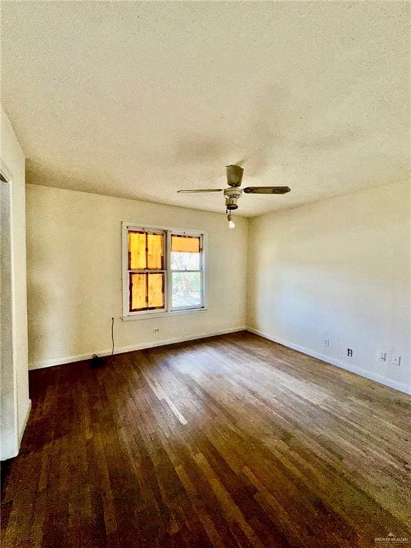 empty room featuring ceiling fan, a textured ceiling, and dark hardwood / wood-style flooring