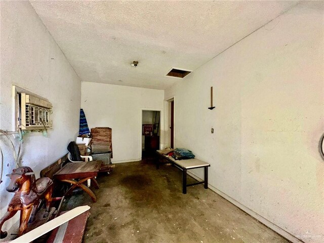 misc room with concrete floors and a textured ceiling