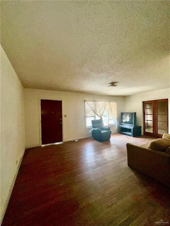 living room with hardwood / wood-style floors and a textured ceiling