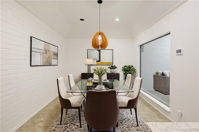 dining area featuring brick wall and ornamental molding