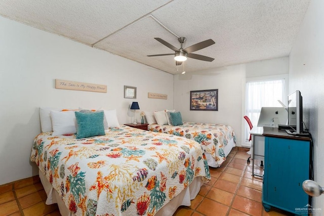 bedroom featuring tile patterned floors, a textured ceiling, and a ceiling fan