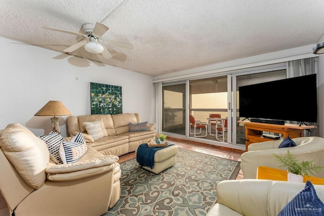 living area with lofted ceiling, a ceiling fan, and a textured ceiling