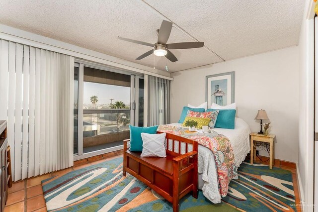 bedroom featuring tile patterned floors, access to outside, a ceiling fan, and a textured ceiling