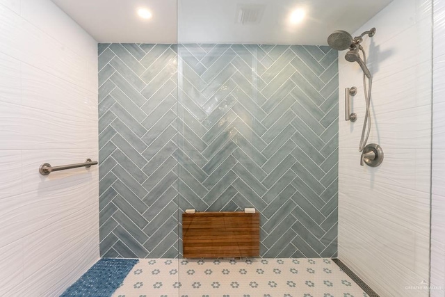 full bath with a tile shower