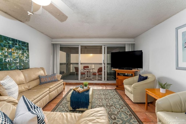 living room with tile patterned floors, a textured ceiling, and a ceiling fan