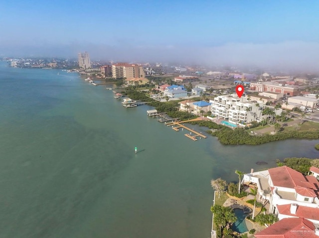 drone / aerial view featuring a city view and a water view