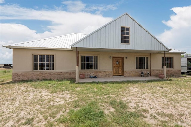 25662 N Fm 681, Edinburg, TX 78541 - view of front of property with stucco siding, a metal roof, a front lawn, and stone siding