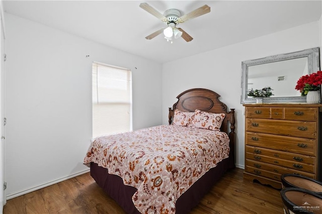 bedroom with a ceiling fan and wood finished floors