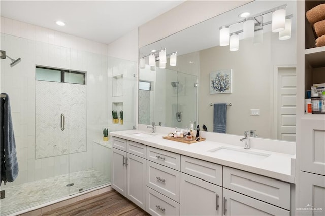 bathroom featuring hardwood / wood-style floors, vanity, and walk in shower