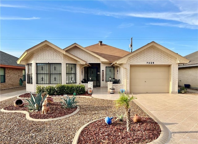 7226 Ford St, Mission, TX 78572 - ranch-style home with brick siding, an attached garage, and concrete driveway