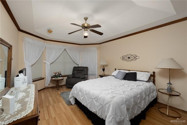 7226 Ford St, Mission, TX 78572 - bedroom with light wood finished floors, crown molding, a tray ceiling, and a ceiling fan