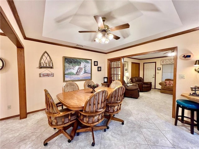 7226 Ford St, Mission, TX 78572 - dining area featuring a tray ceiling, light tile patterned floors, ceiling fan, crown molding, and baseboards