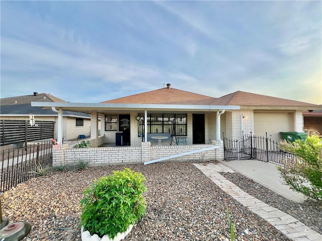 7226 Ford St, Mission, TX 78572 - view of front of home featuring brick siding, covered porch, and an attached garage