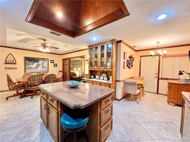 7226 Ford St, Mission, TX 78572 - kitchen featuring a chandelier, a raised ceiling, a kitchen island, recessed lighting, and crown molding