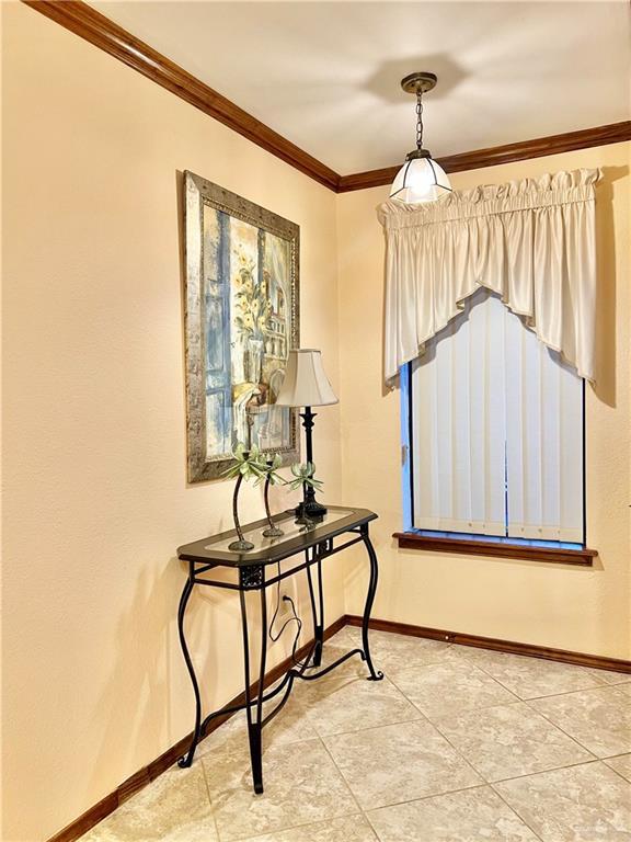 7226 Ford St, Mission, TX 78572 - spare room featuring ornamental molding, baseboards, and light tile patterned floors
