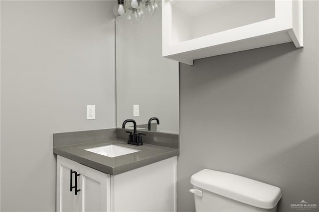 bathroom with toilet and vanity