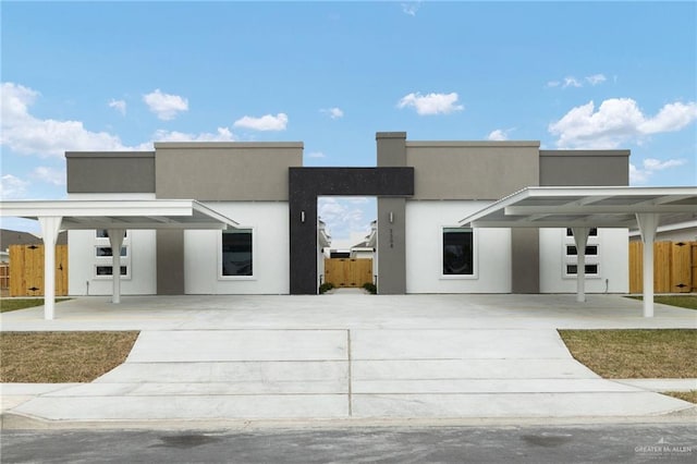 view of front of house with fence and stucco siding