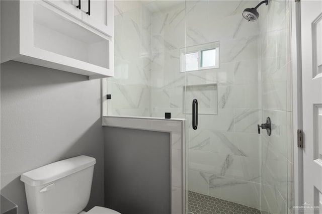 bathroom with a stall shower and toilet