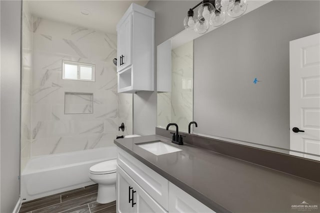 bathroom featuring toilet, bathing tub / shower combination, wood tiled floor, and vanity