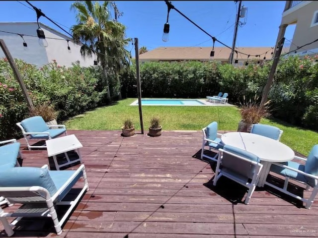 102 E Tarpon St, South Padre Island, TX 78597 - wooden terrace featuring an outdoor pool, a yard, and outdoor dining space