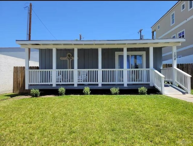 102 E Tarpon St, South Padre Island, TX 78597 - view of front of property featuring covered porch and a front lawn