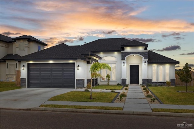 3100 Silver Oak Ave, Mission, TX 78574 - french provincial home featuring stone siding, an attached garage, concrete driveway, and a yard