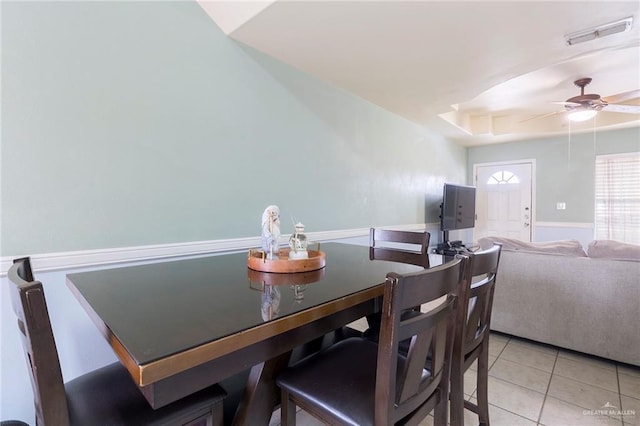 tiled dining area with ceiling fan