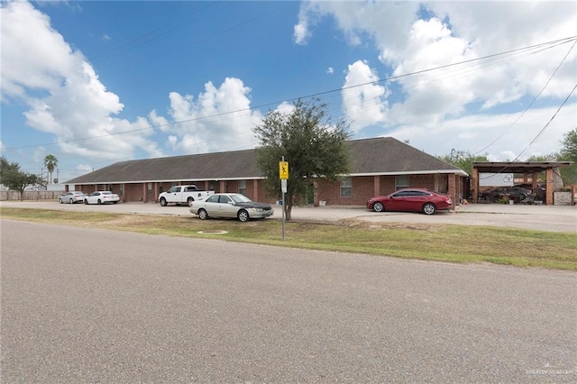 ranch-style house with a front lawn and a carport