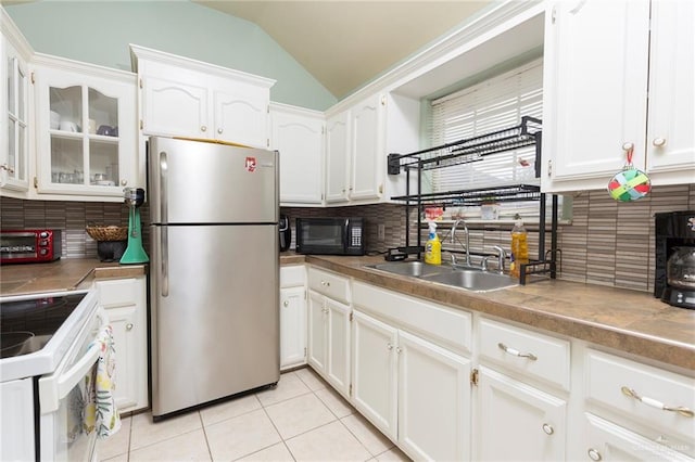 kitchen with decorative backsplash, stainless steel fridge, sink, and white electric range