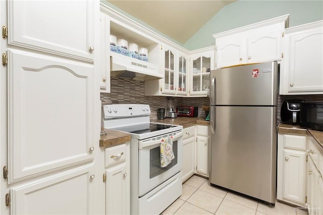 kitchen with white range with electric cooktop, vaulted ceiling, stainless steel refrigerator, and white cabinetry