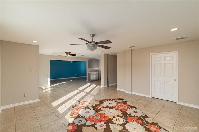 unfurnished living room with ceiling fan and light tile patterned floors