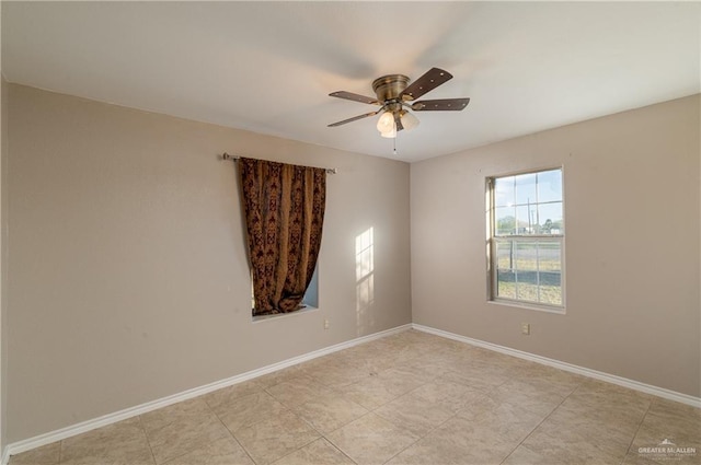 tiled empty room featuring ceiling fan